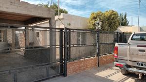 a pick up truck parked in front of a fence at Ester in San Antonio Oeste