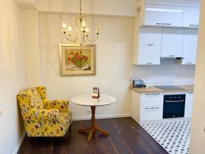 a small kitchen with a table and a chair at Harmony apartment in Bishkek +5 photos