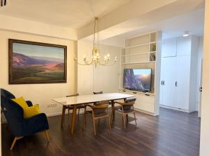 a dining room with a table and chairs at Harmony apartment in Bishkek