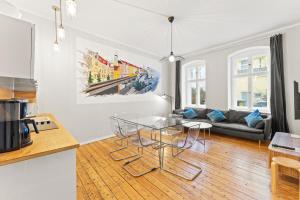 a kitchen and living room with a glass table at primeflats - Apartments Genter Berlin-Wedding in Berlin