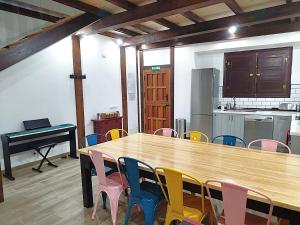 a room with a table and chairs and a piano at Casa Dana, Losar de la Vera in Losar de la Vera