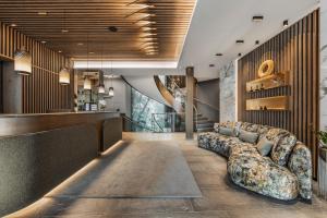 a living room with a couch in a lobby at Hotel Fliana 4-Sterne Superior in Ischgl