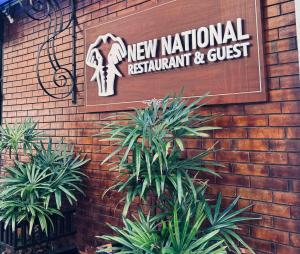 a new national restaurant and guest sign on a brick wall at New National in Pettah