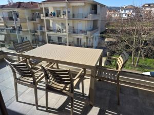 a table and chairs on the balcony of a apartment at Velithea Luxury Suites in Ioannina