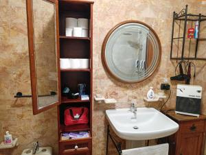a bathroom with a sink and a mirror at La Corte Nelle Vigne in Lavagno +17 photos