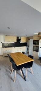 a kitchen with a wooden table and chairs at Gite Rive Charente La Cabane in Bords +14 photos