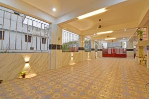 an empty lobby with a tile floor and windows at SRK Residency in Pūrnānkuppam +103 photos