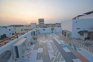 a balcony of a building with a sunset in the background at SRK Residency in Pūrnānkuppam