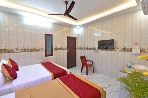 a hotel room with a bed and a bathroom at SRK Residency in Pūrnānkuppam