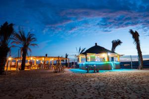 a wedding on the beach at night at Eden Lodge - Desert Camp in Kébémèr