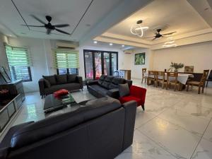 a living room with couches and a dining room at Permas Jaya Corner Homestay -Event -Party -TablePool -Karaoke -BBQ in Johor Bahru