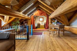 a living room with wooden ceilings and a wooden table at Hostdomus - Chalet Wood in Sauze d'Oulx