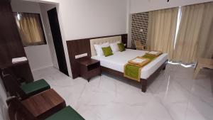a bedroom with a large bed and a chair at Machan Villas by Holiday Club in Bhor +36 photos