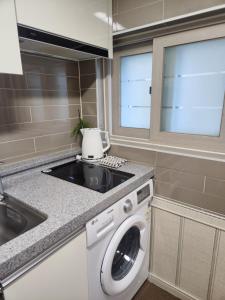 a kitchen with a washing machine and a sink at DASOM in Busan