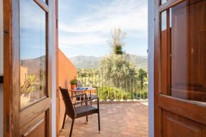 a door to a balcony with a chair and a table at Villa Moscari in Moscari