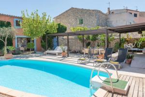 a swimming pool with a patio and a house at Villa Moscari in Moscari