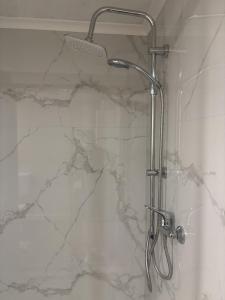 a shower in a bathroom with a marble wall at Apartman Loni , Belišće in Belišće +37 photos