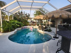 a swimming pool in the middle of a patio at Ocean Spa Oasis in Port Saint Lucie