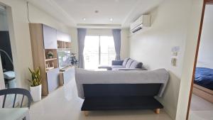 a living room with a couch and a bed at The Two bedrooms Two bathrooms in Phuket Old Town in Phuket