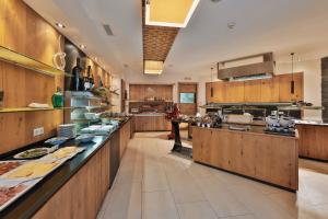 a large kitchen with wooden cabinets and counters at Hotel Fliana 4-Sterne Superior in Ischgl