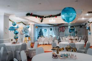 a room with white tables and blue balloons at Ashburnham Hotel in Pembrey