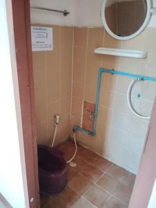 a small bathroom with a toilet and a shower at 14 Hostel DMK airport in Bang Khen
