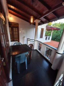 a room with a table and chairs and a house at Sethun House in Mirissa +41 photos