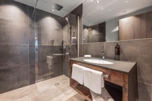 a bathroom with a sink and a shower at Chalet Fliana Deluxe in Ischgl +20 photos