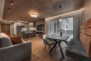 a living room with a couch and a table at Chalet Fliana Deluxe in Ischgl