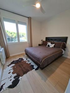 a bedroom with a large bed and a large window at Apartment Beach Front Sant Pol in San Pol de Mar