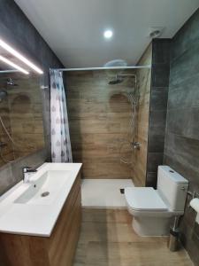 a bathroom with a sink and a toilet and a shower at Apartment Beach Front Sant Pol in San Pol de Mar +34 photos