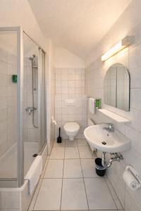 a bathroom with a sink and a shower and a toilet at Silvio-Gesell-Tagungsstätte in Wuppertal