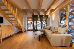a living room with a couch and a table at Old Coach House in Bled