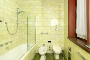 a bathroom with a toilet and a sink and a shower at Villa Inella in Oggiono