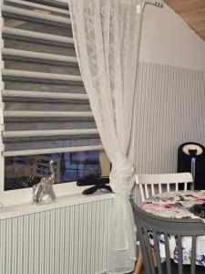 a room with a staircase with a window and a chair at Agroturystyka Nad Stawem in Sulęcin +15 photos