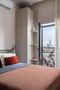 a bedroom with a bed and a balcony at Blueloft 65 I Apartment with Balcony and City View in Tashkent