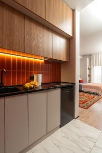 a kitchen with white cabinets and a sink at Blueloft 65 I Apartment with Balcony and City View in Tashkent