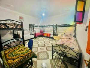 a bedroom with two bunk beds in a room at Blue Star Hostel in Fez