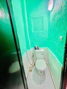 a bathroom with a toilet in a blue room at Blue Star Hostel in Fez