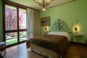 a bedroom with a bed and a large window at Villa Inella in Oggiono