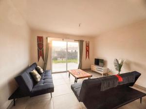 a living room with a couch and a table at Maison 5-6 personnes -15 min du Parc - Parking -by R&G in La Pommeraie-sur-Sèvre