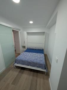 a small bedroom with a bed in a room at Bajo Alcobendas in Alcobendas