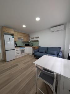a kitchen and living room with a table and a couch at Bajo Alcobendas in Alcobendas