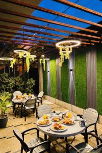 a patio with tables and chairs with food on it at Holiday One Hotel & Suites - Gulshan-4 in Karachi