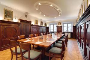 a large dining room with a long table and chairs at Posthotel Kolberbräu in Bad Tölz
