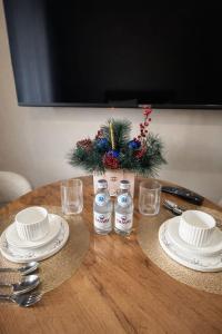 a table with plates and glasses on top of it at Современный апартамент Tandau в центре in Almaty