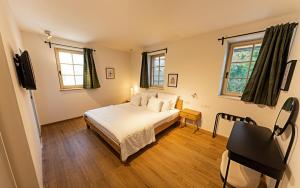 a bedroom with a bed and a television in it at Old Coach House in Bled