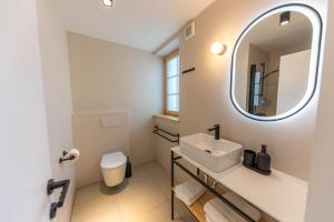 a white bathroom with a sink and a mirror at Old Coach House in Bled +25 photos