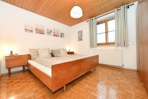 a bedroom with a bed and a wooden floor at Ferienhof Kopf in Mäder