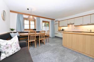 a kitchen and living room with a table and chairs at Ferienhof Kopf in Mäder